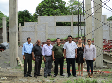 National church staff and project engineer pose in front of the project. Photo: Trevor Main.