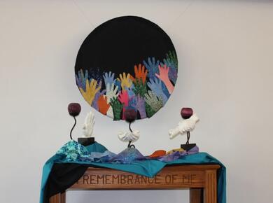 raised hands artwork with dove sculptures