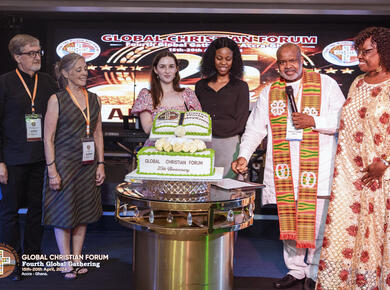 a white couple, two young women, an african couple display an anniversary cake