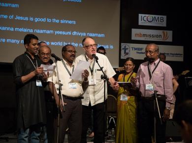 <p>David Wiebe sings along with the India delegation at the ICOMB summit on mission and prayer in Thailand 2017. Photo: John Ervin.</p>