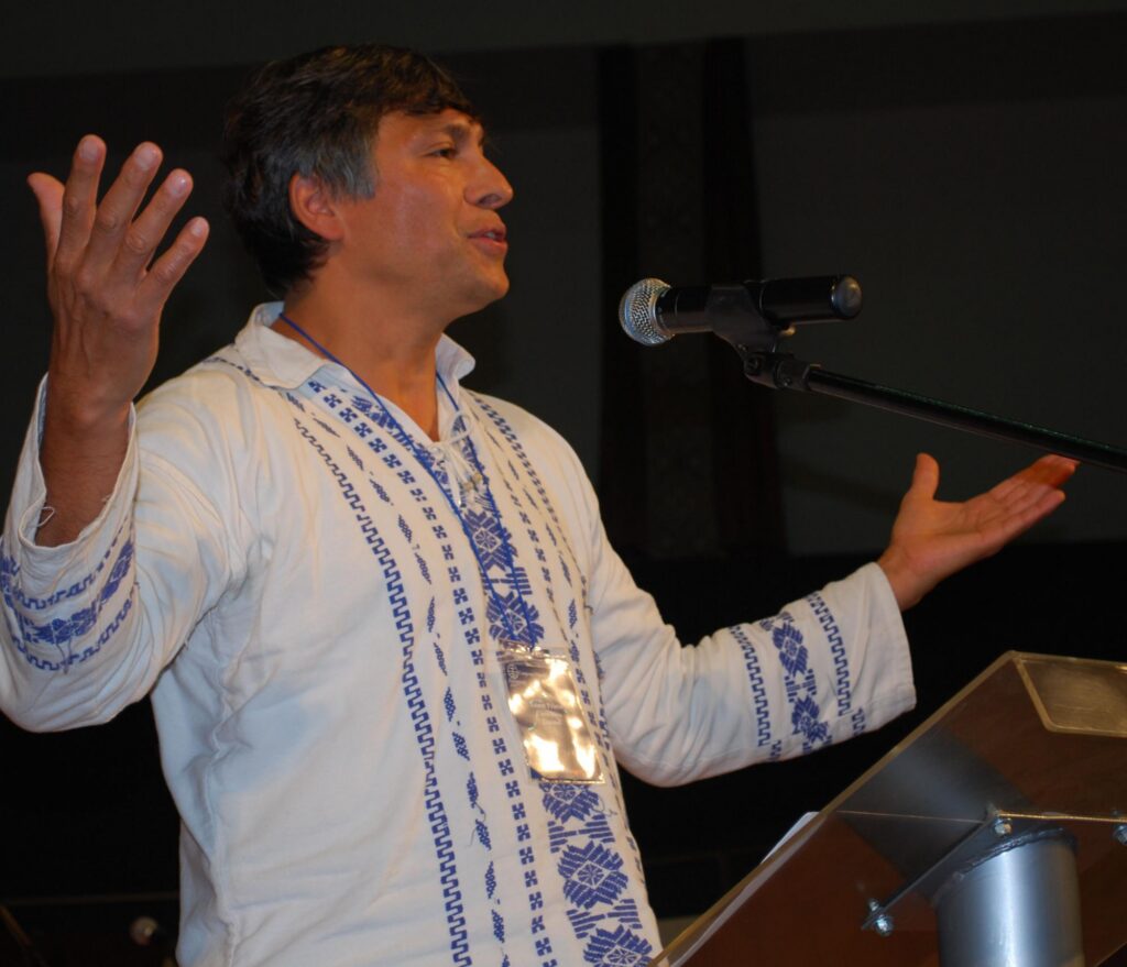 man in white shirt with arms open wide