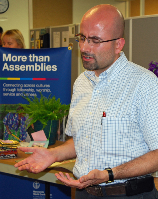 bald man with closed eyes and hands open in front of him