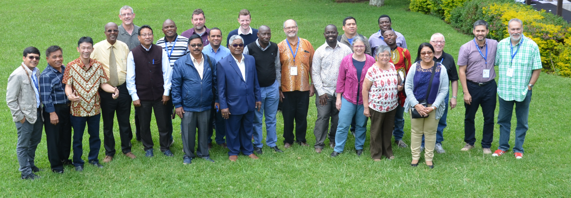 Global Anabaptist Service Network (GASN). A group of people standing on grass, smiling