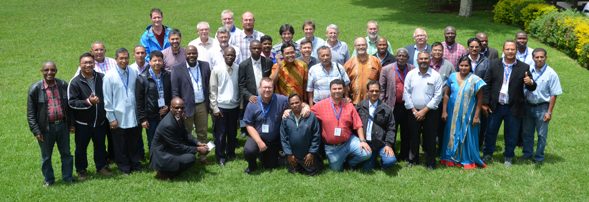 Global Mission Fellowship (GMF), a group of people, some standing and other crouching in grass, smiling