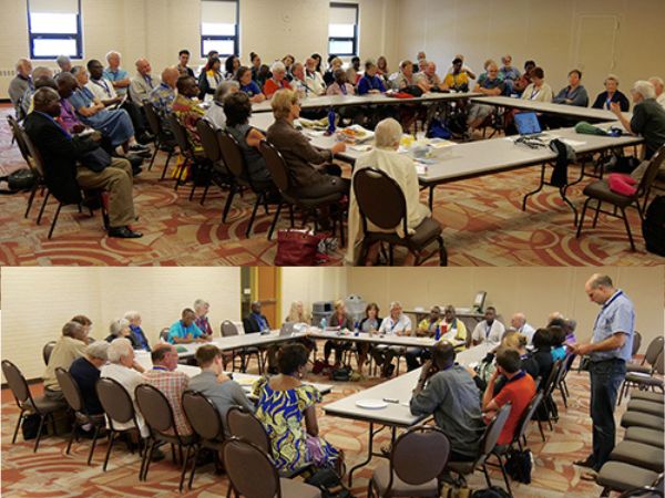 large group of people around tables arranged in a square
