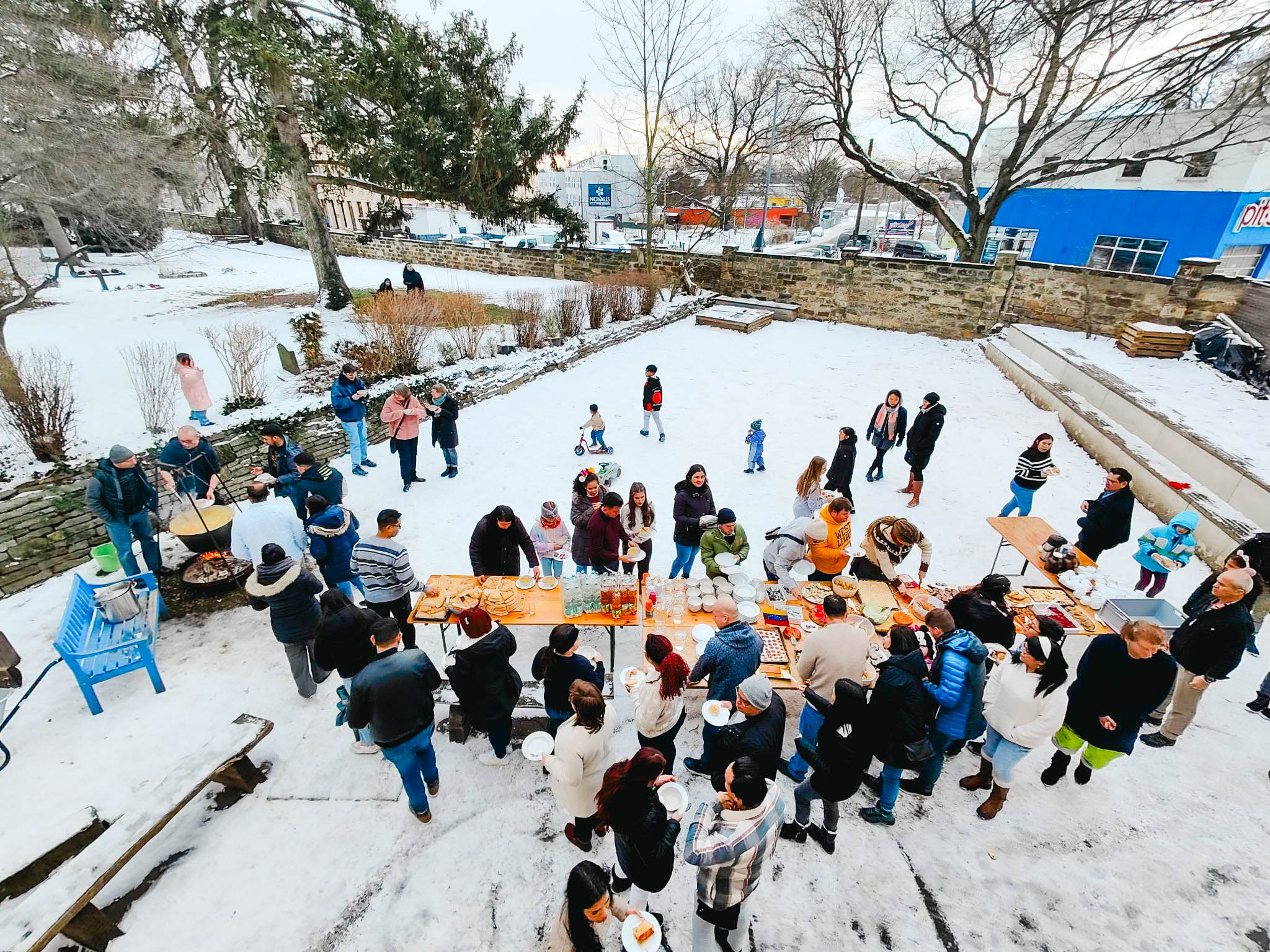 Evangelisch-mennonitische Freikirche, Dresden, Germany, shares a meal outside with refugees from Venezuela as part of their Anabaptist World Fellowship Sunday celebration in 2024.