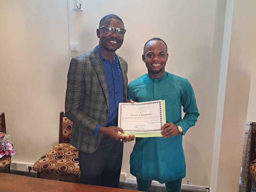 Jonathan Nguerassem (MCC program coordinator) awards Moses Jumbo a certificate from the Evangelical Association for Peace and Justice, Chad, for a successful service year and partnership.