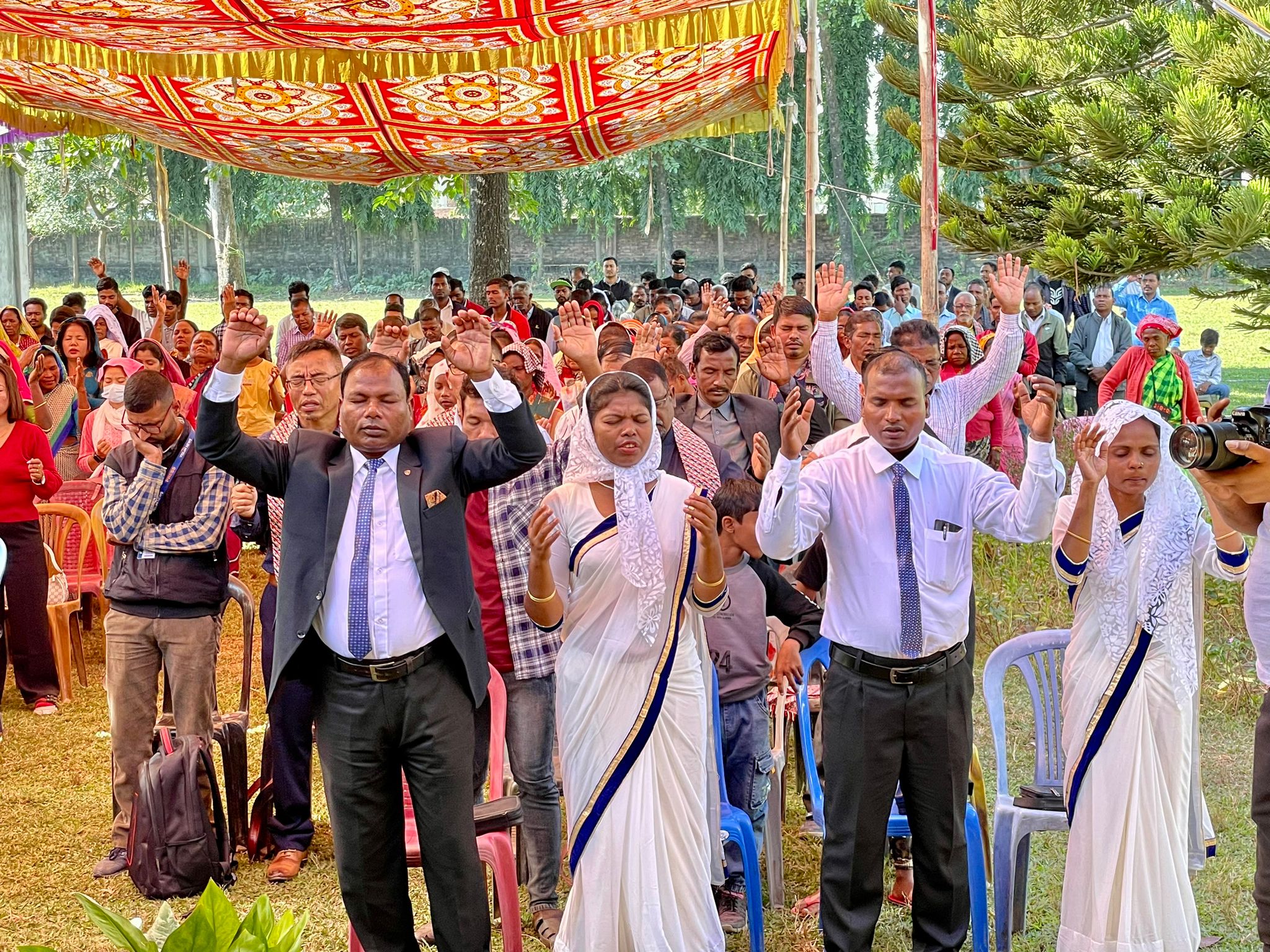 members and leaders of Nepali church praying together