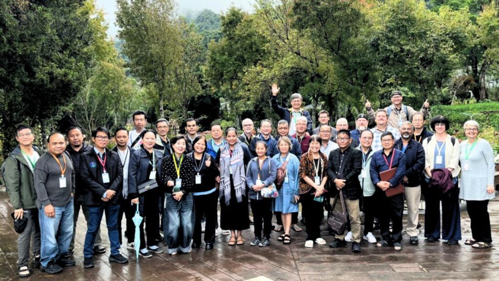 large group of Asian people lined up for photo