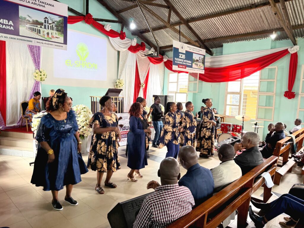 African women's choir stand at the front of the church