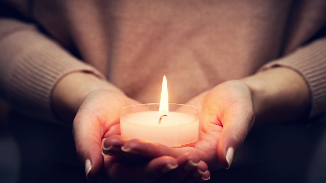 hands holding a candle