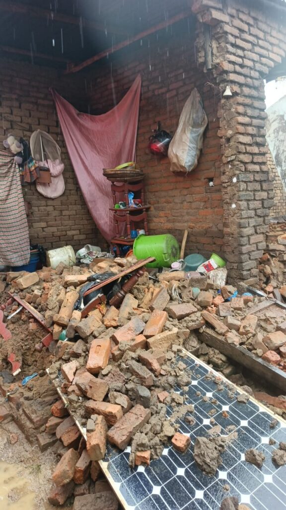 broken bricks collapsed in on building with solar panel underneath