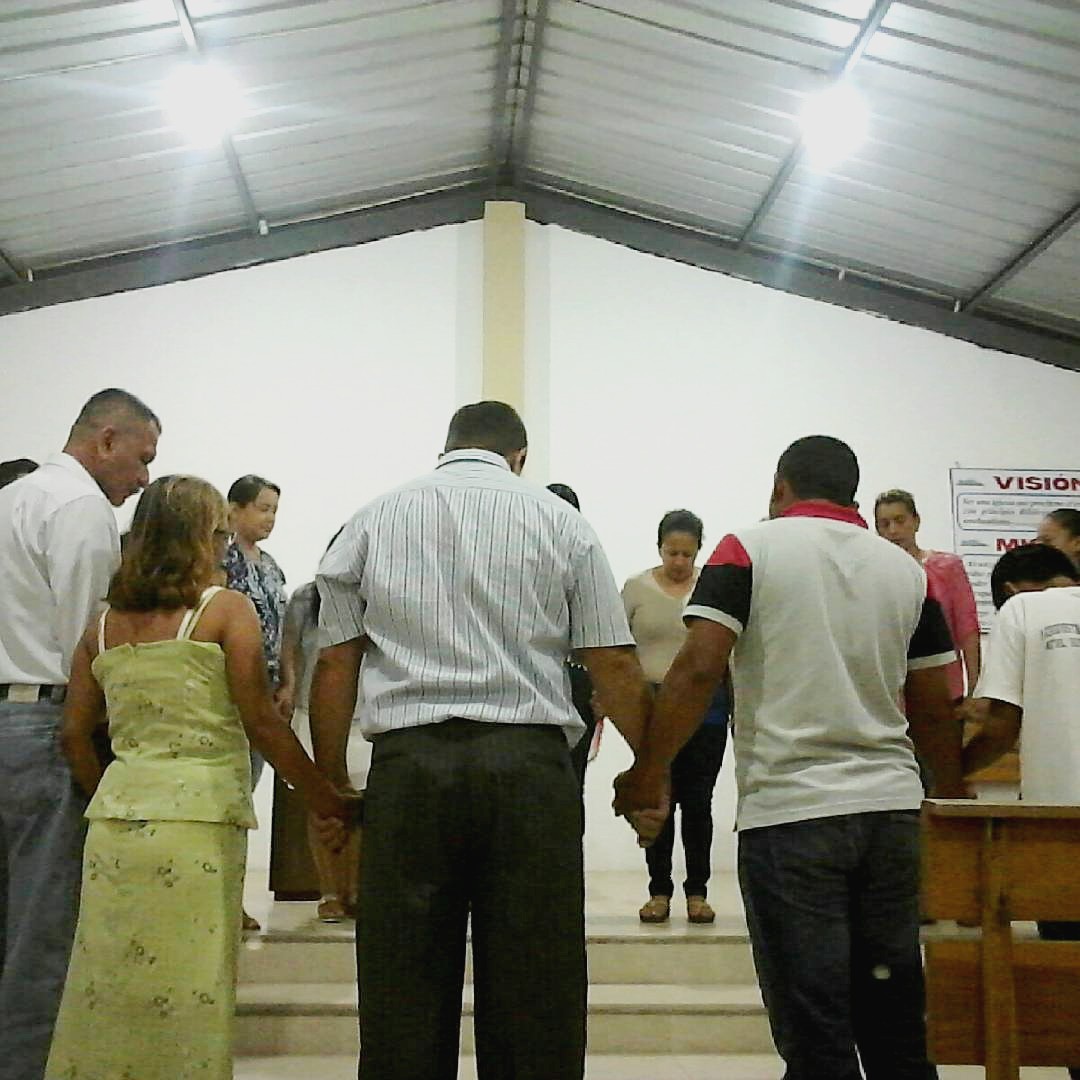 church members praying together hand in hand
