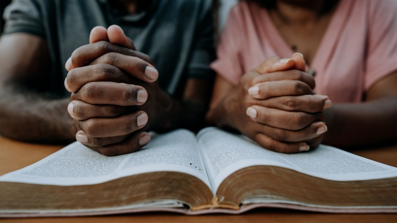 an African couple praying together